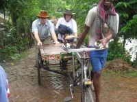 John and Rob pushing a rickshaw up a hill