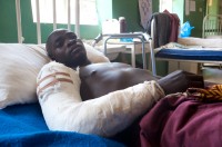 John Mwanti, receiving treatment in Vom Christian hospital for a gunshot wound to his right arm.